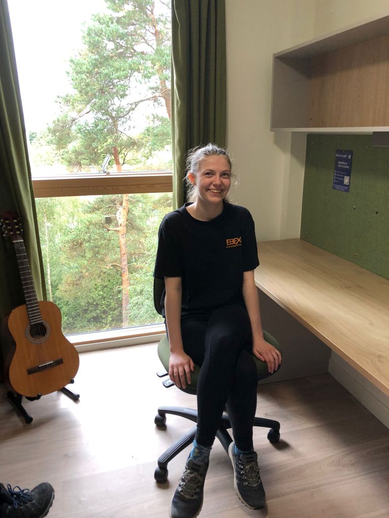 Elizabeth sitting at Daniel's desk.