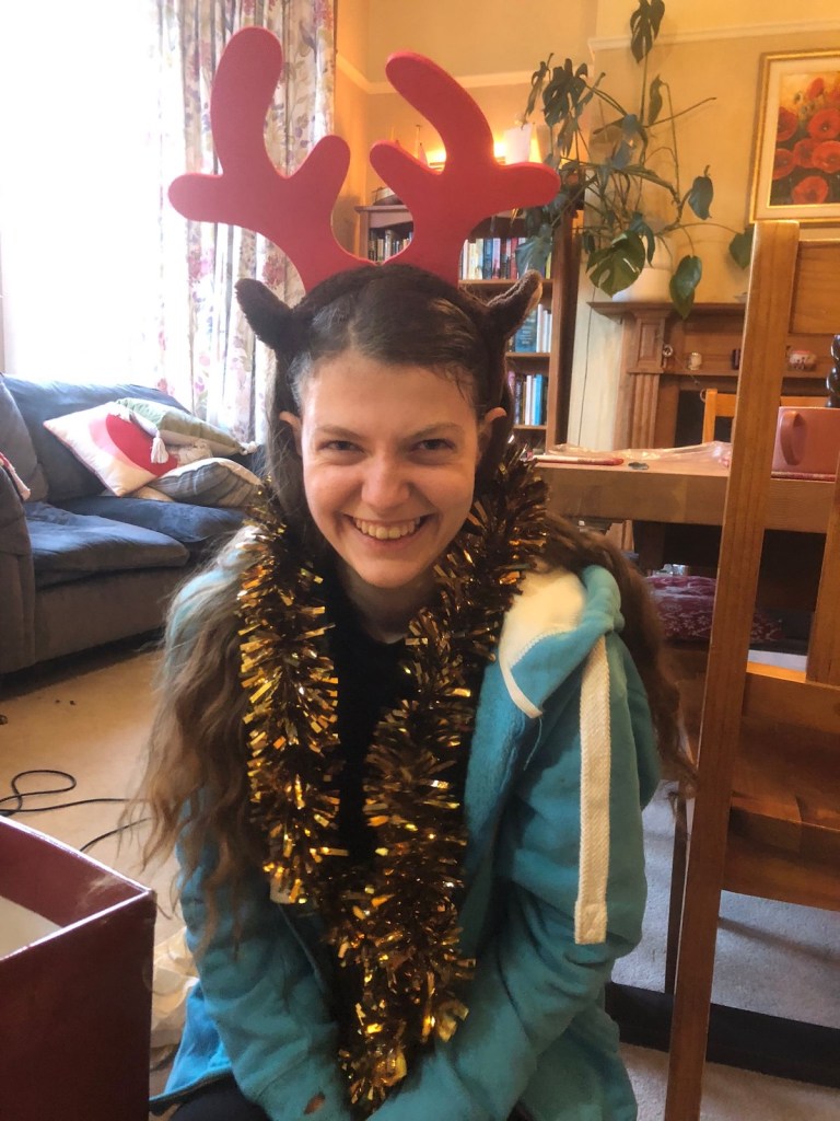 Elizabeth wearing reindeer ears and tinsel