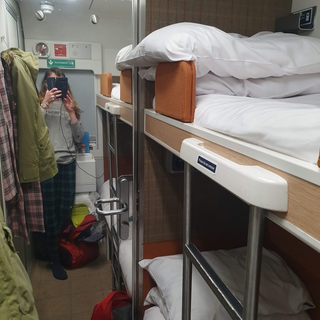 Another shot of the cabin with me showing the beds.