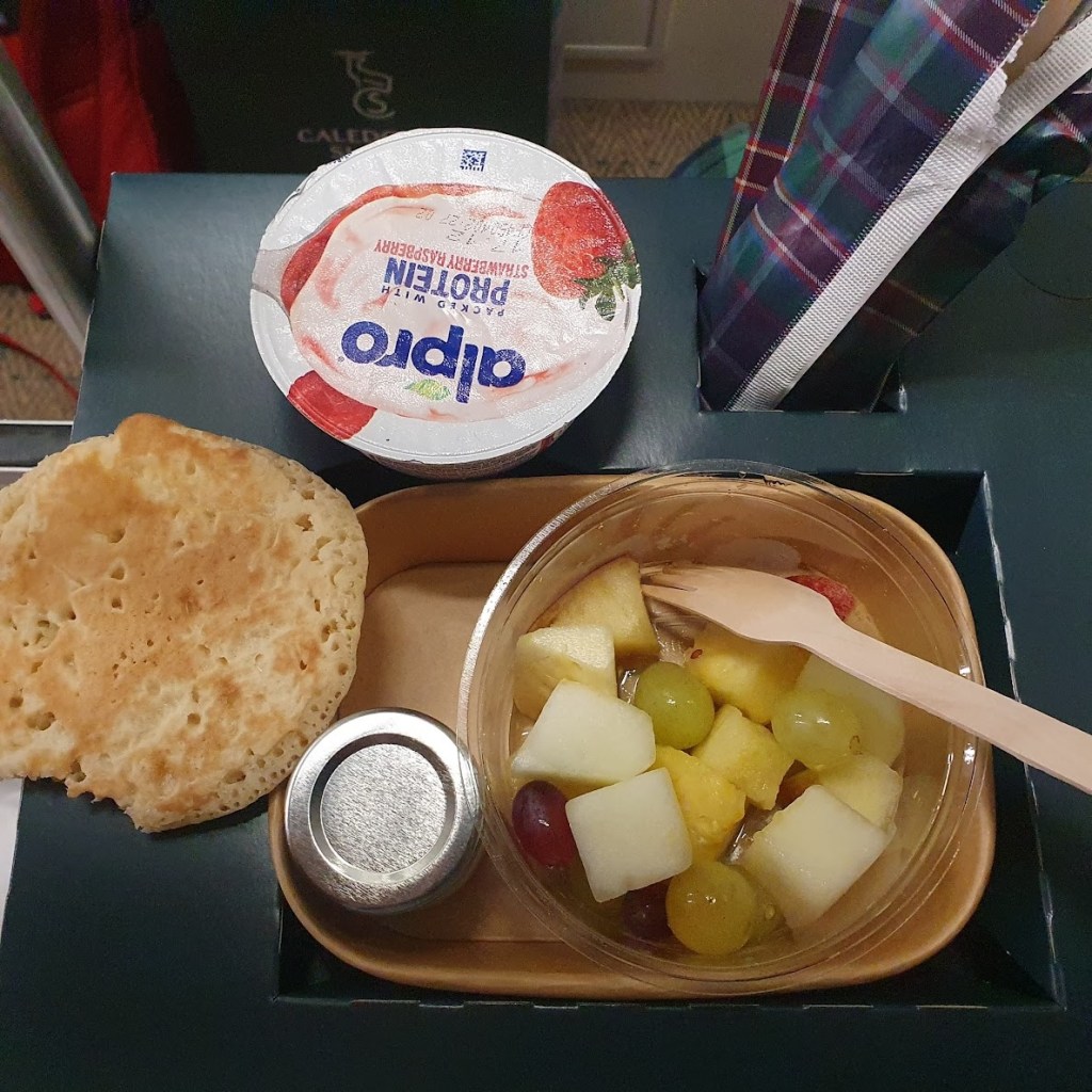 Breakfast of fruit, yoghurt and pancake.