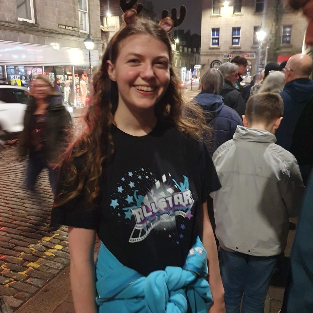 Elizabeth wearing only a tshirt outside in Aberdeen's winter. We're lining up waiting to go in.
