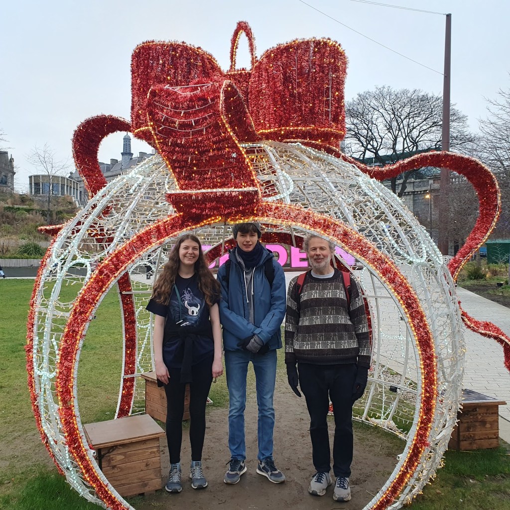 A Christmas bauble in Union Terrace gardens with Elizabeth, Daniel and Ben.