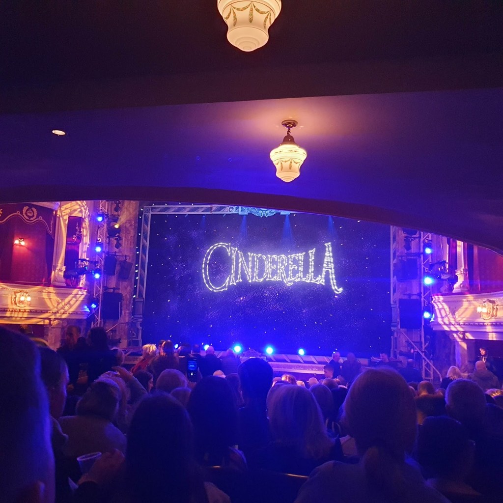 The stage with Cinderella in sparkly lights on the curtain.