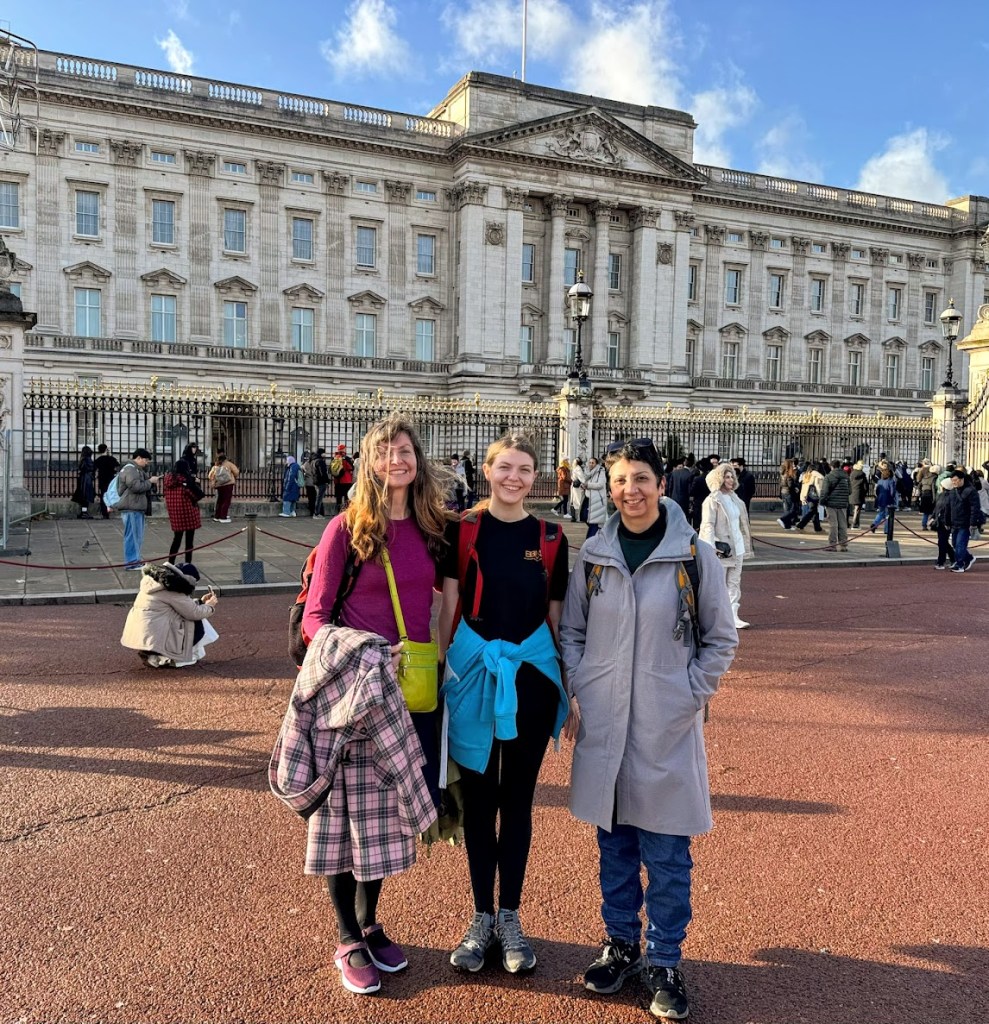 Elizabeth, Rachel and Diya in front of Buckingham Palace.