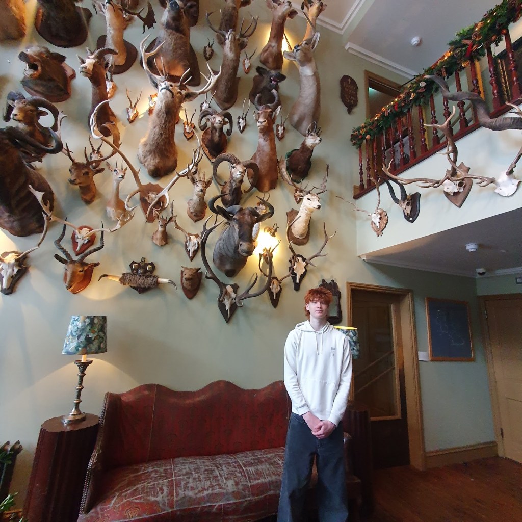 Oscar in front of the wall of death at the Fife Arms