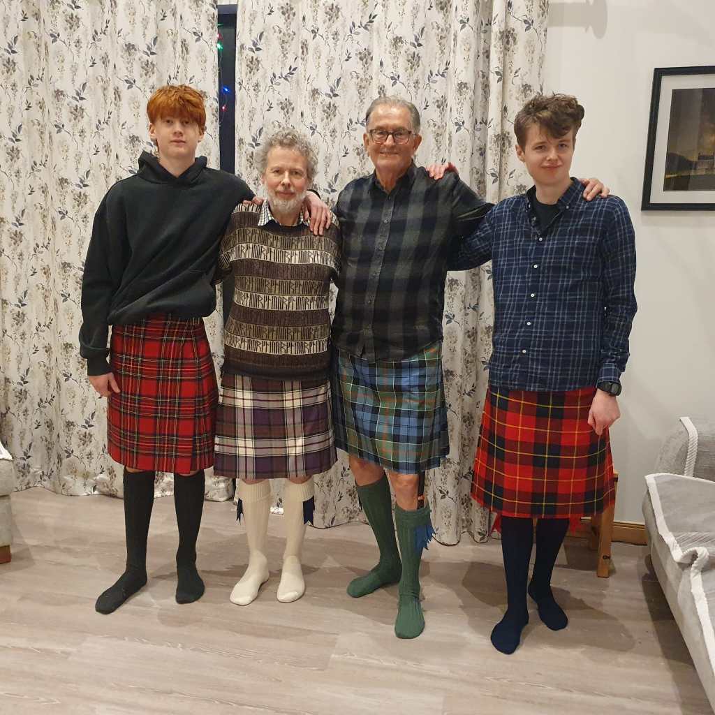 Oscar, Ben, Dad and Daniel wearing their kilts.