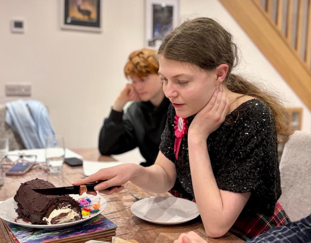 Elizabeth cutting her yule log cake