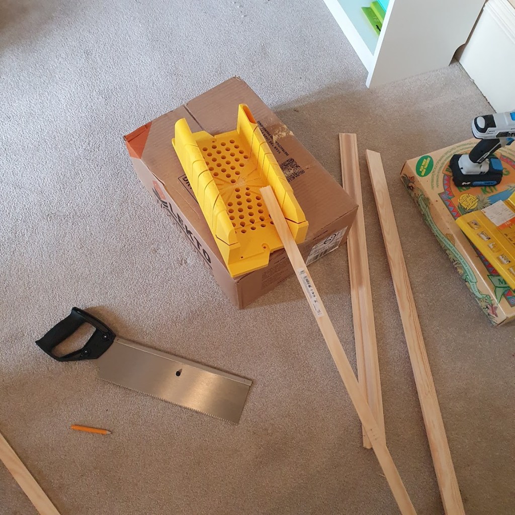 The saw, mitre and strips of pine