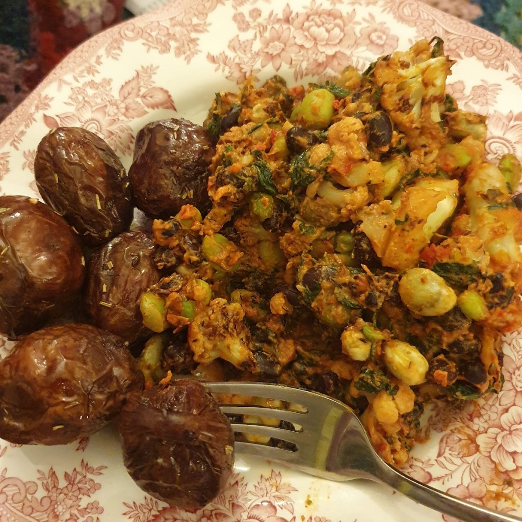 Dinner of roast purple potatoes plus a bean and cauliflower dish