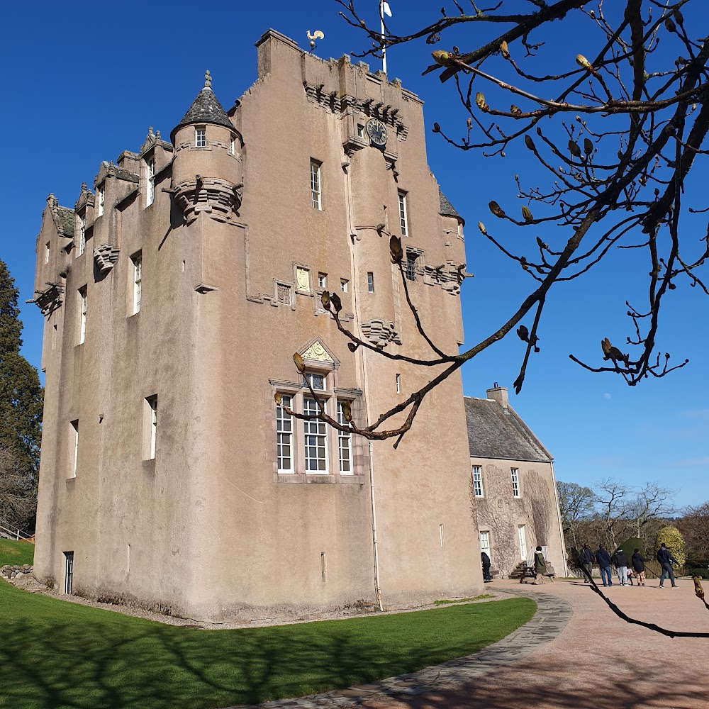 Crathes Castle with a bright blue sky behind.
