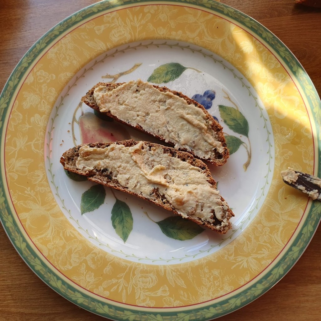 Two pieces of sourdough smeared with hummus