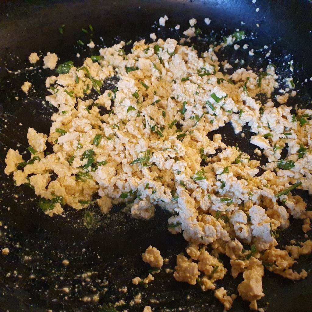 Scrambled tofu frying on the pan
