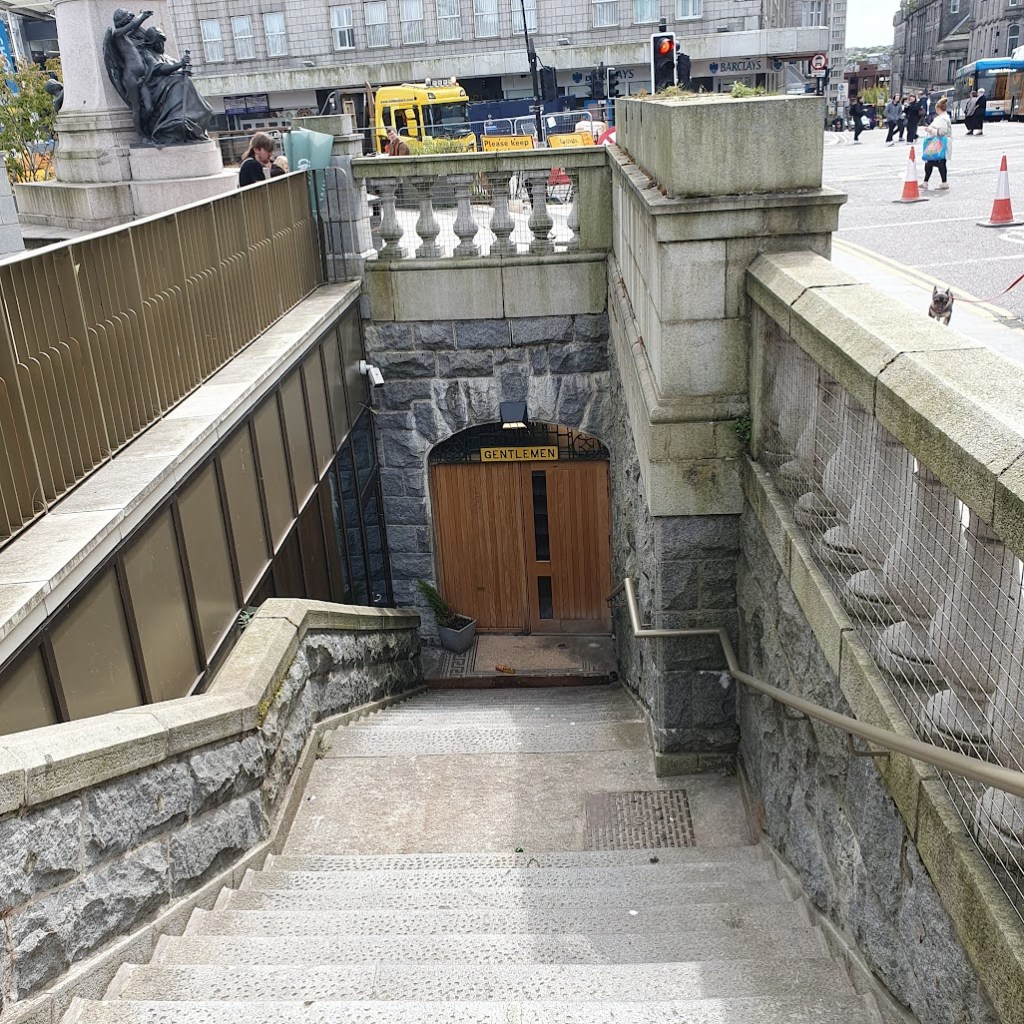 Victorian toilets under Union Street - a wooden door with the sign "Gentlemen" above it at the bottom of some steps.