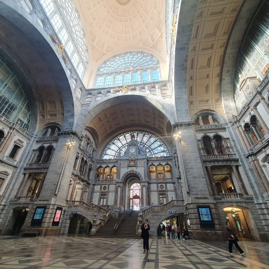 Antwerp's railway station showing the tiled floor, stairway in the main train area and the domed roof