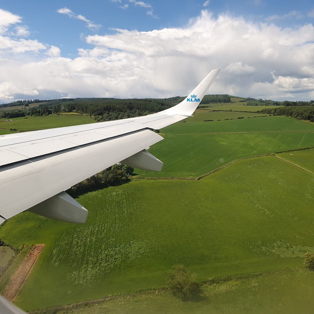Green fields and the wing of KLM as it was coming in to land in Aberdeen