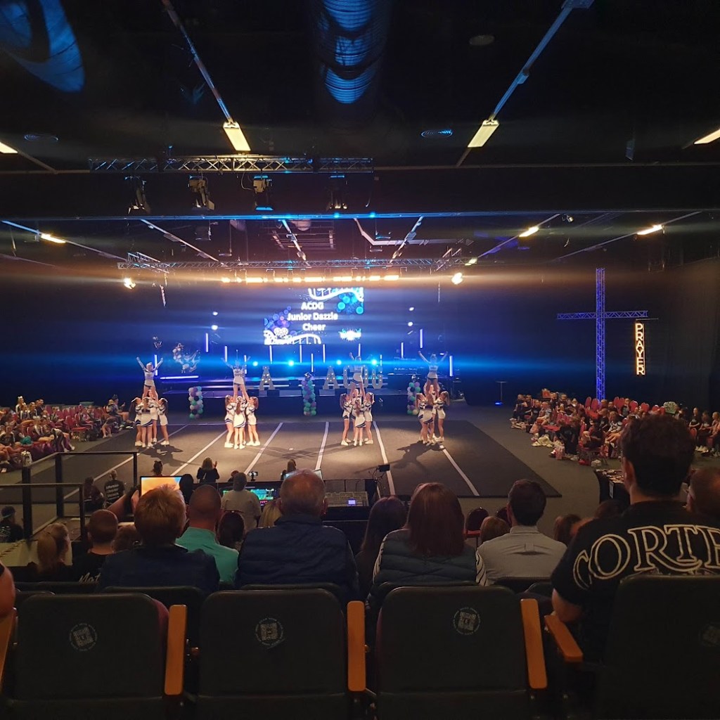 The stage at the show with four groups all balancing an athlete in the air
