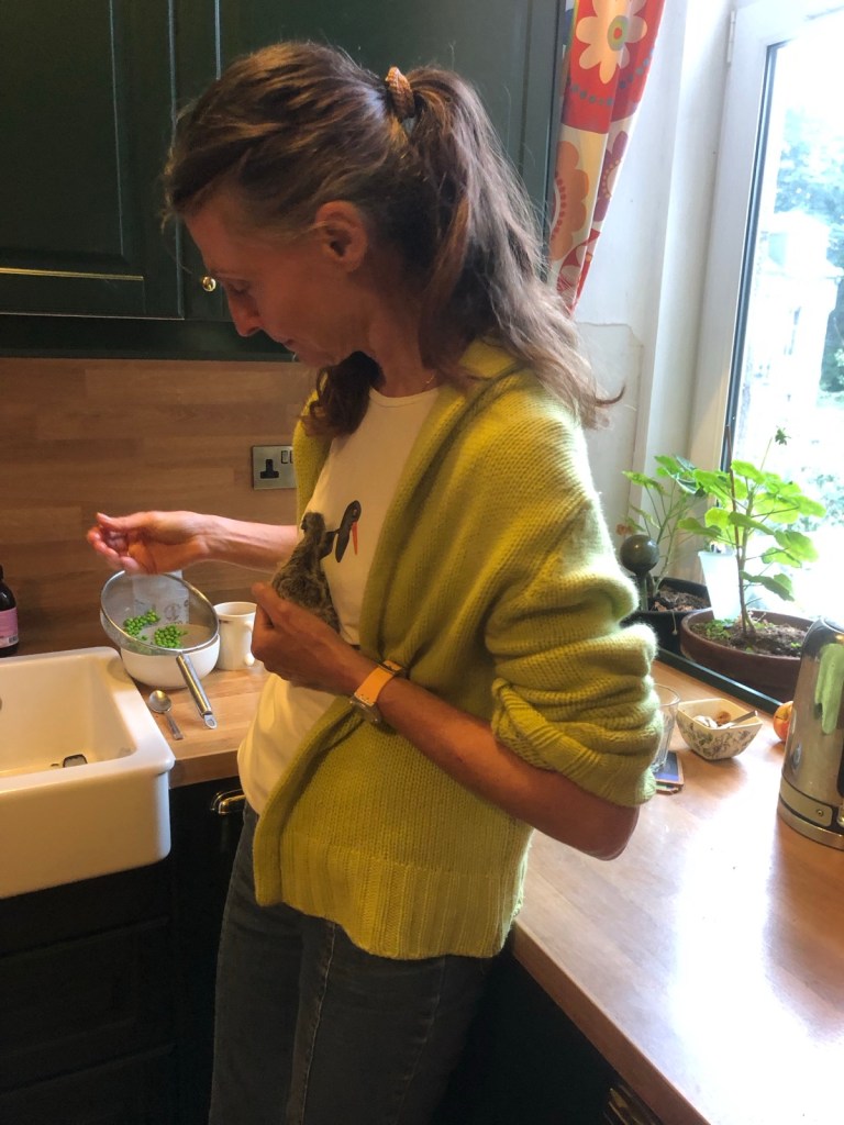 Me holding Mary and feeding her peas.