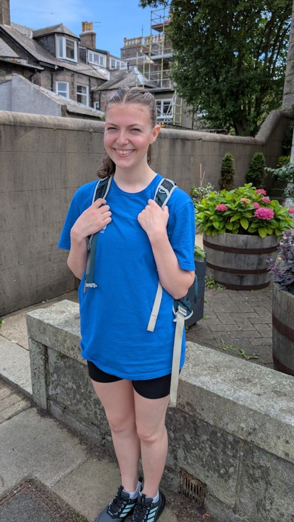 Elizabeth on the street with her backpack ready to go to the first show today