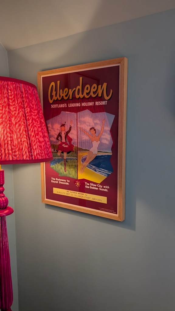Vintage poster with a highland dancer and a woman at the beach the heading says, "Aberdeen Scotland's leading holiday resort".
