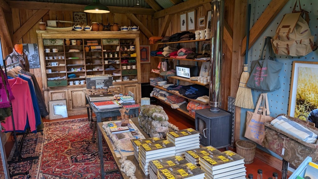 Inside the store with shelves of interesting things to look at including books, bags, scarves, socks, jumpers etc.