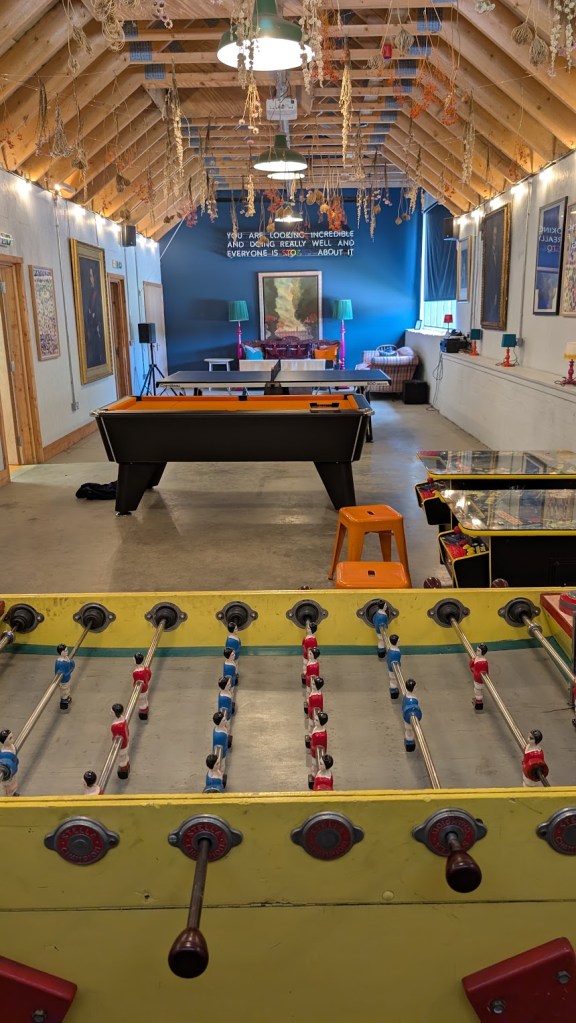 Inside the clubhouse showing the pool table, arcade games and table tennis.