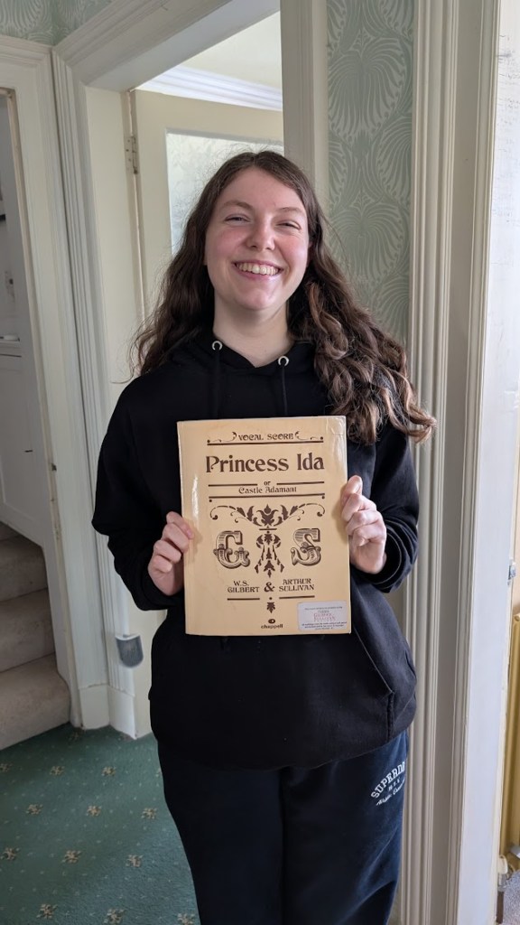 Elizabeth holding the score for Princess Ida