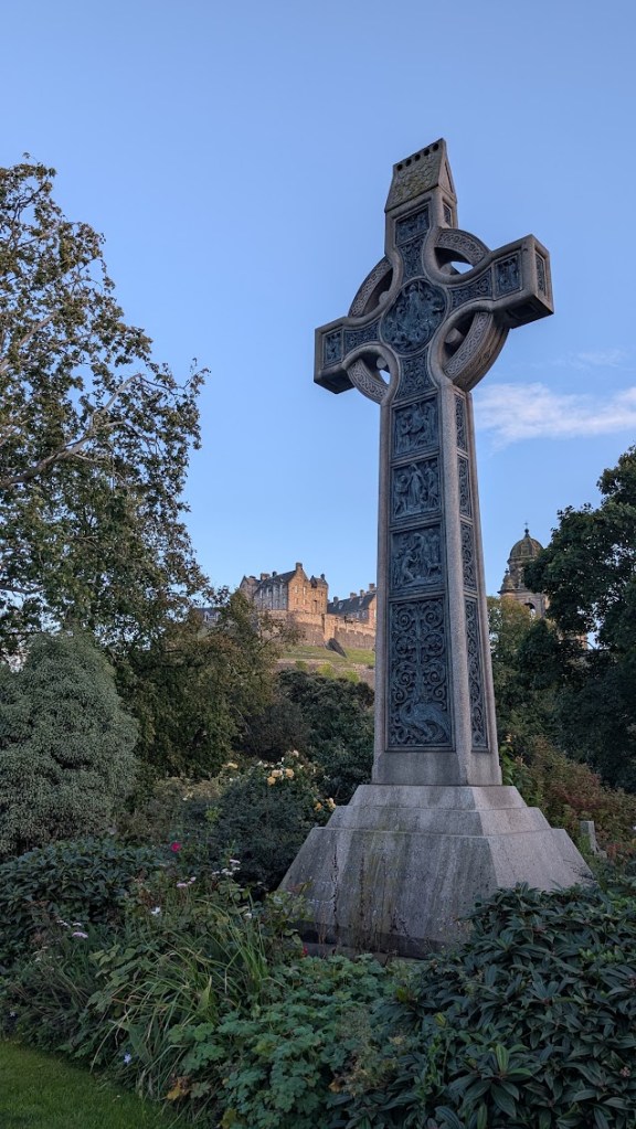 Looking up towards the castle with a cross in the foreground