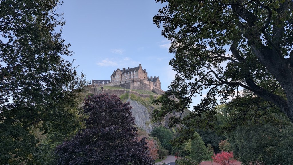 Edinburgh Castle on the hilltop, peering through the trees